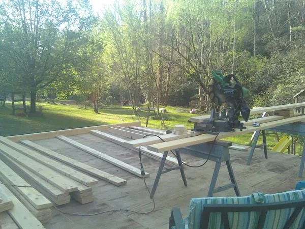Miter saw and framing lumber on a deck under construction in Allenhurst